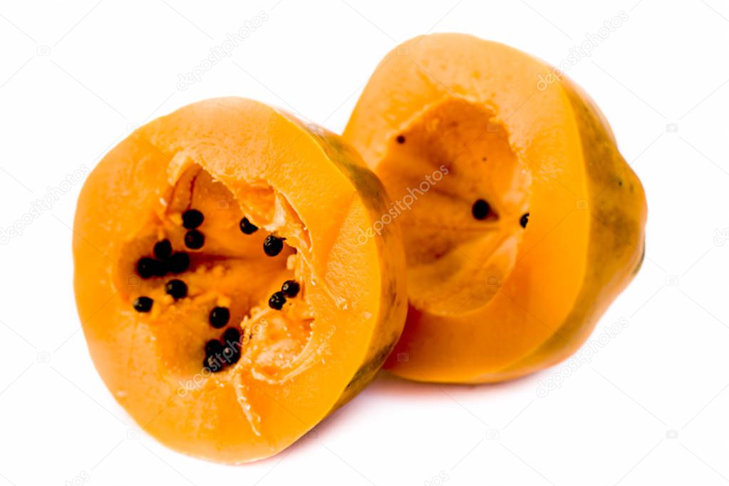 Raw organic cut papaya isolated on white.