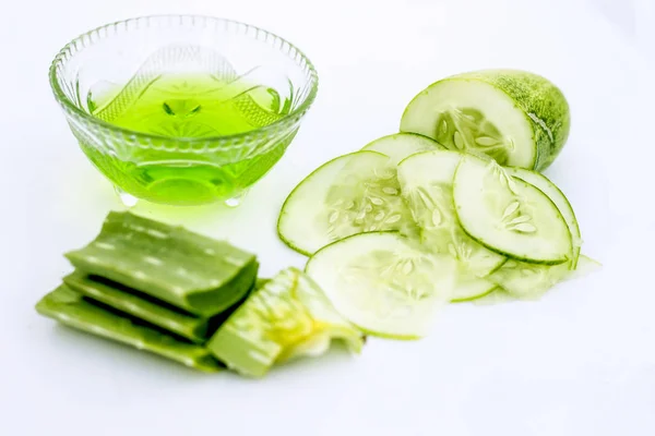 Raw cucumber along with some aloe vera gel well mixed in a glass bowl isolated on white entire ingredients.Used to rejuvenate your skin and for instant glow.