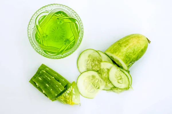 Raw cucumber along with some aloe vera gel well mixed in a glass bowl isolated on white entire ingredients.Used to rejuvenate your skin and for instant glow.