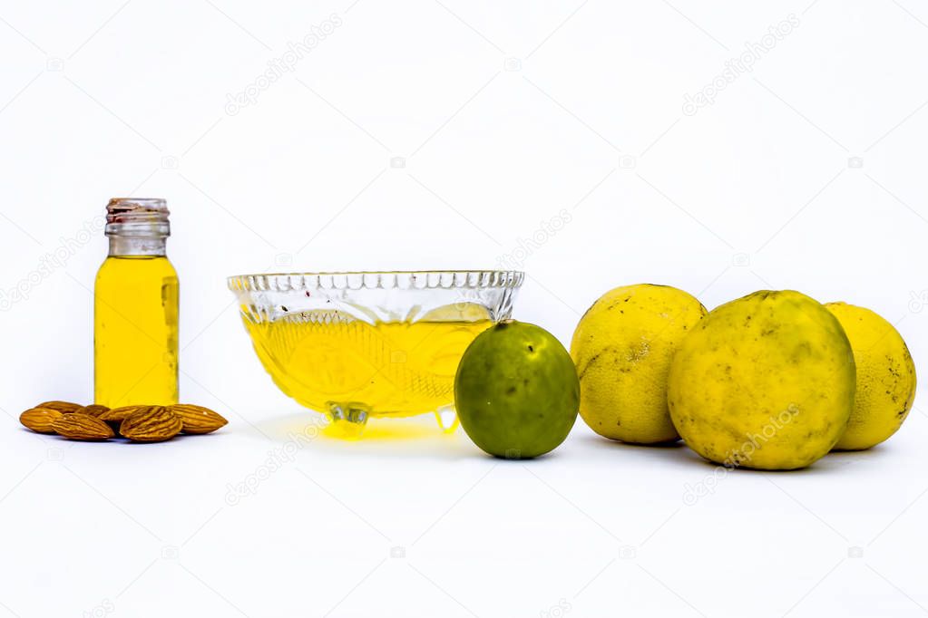 Hair conditioner isolated on white i.e. Almond oil and lemon juice well mixed in glass transparent bowl.Entire ingredients present on the surface.