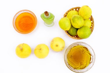 Lemon hair growth mask isolated on white i.e. Lemon juice well mixed with honey and Olive oil in a glass bowl with entire raw ingredients. clipart