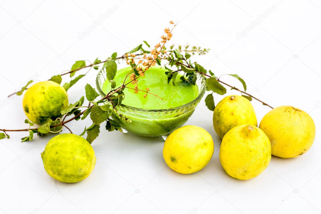 Lemon face pack isolated on white i.e. lime juice well mixed with tulsi or holy basil's juice.Used for the treatment or to remove dirt,dust and other impurities.