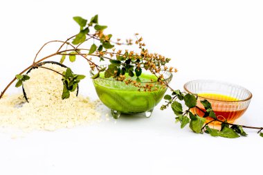 Fesleğen yüz maskesi beyaz yani basil yaprakları suyu iyi bal ve gram un ile bir kapta ve tüm ham maddeler yüzeyinde mevcut karışık. Anlık akne ve sivilce ücretsiz kızdırma için kullanılır.