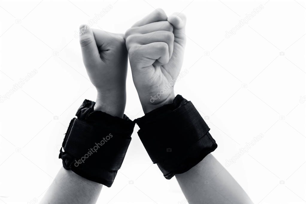 Human hands one of male and another one of female isolated on white wearing black colored wrist bands or wrist weights isolated on white.Doing various hand expressions to show unity and strength.
