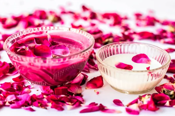 Rose petals and milk face pack isolated on white along with some rose petals and milk.Used to have instant glow.