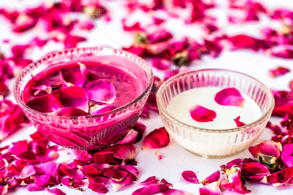 Rose petals and milk face pack isolated on white along with some rose petals and milk.Used to have instant glow.