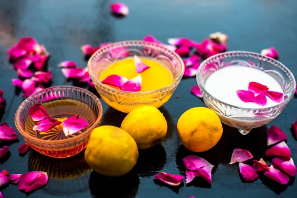 Milk face pack in a glass bowl used for brighter skin on wooden surface consisting of raw milk,honey and lemon juice.