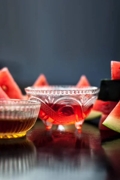 Watermelon face pack or face mask for extra soft glowing skin especially for the type of people having oily skin,Consisting of Watermelon pulp and honey well mixed in a glass bowl,Vertical shot.