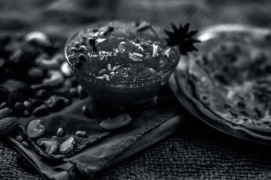 Ünlü mango koruma yani Murba veya Murabba onunla kuru meyve ve spcies ile birlikte jüt çanta yüzeyinde bir cam kase. Arka plan bulanık yatay çekim, bazı chapatis veya roti ile birlikte.