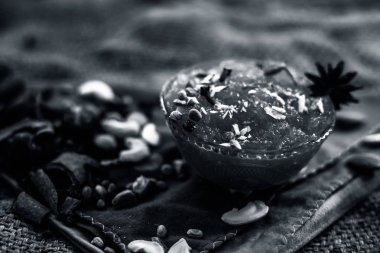 Ünlü mango koruma yani Murba veya Murabba jüt çanta yüzey üzerinde bir cam kase kuru meyve ve baharat ile birlikte. Arka plan bulanık yatay çekim.