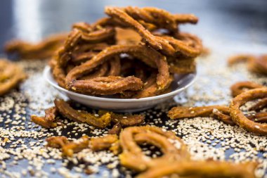 Ahşap yüzeyinde ham susam ile plaka Ünlü Hint çerez