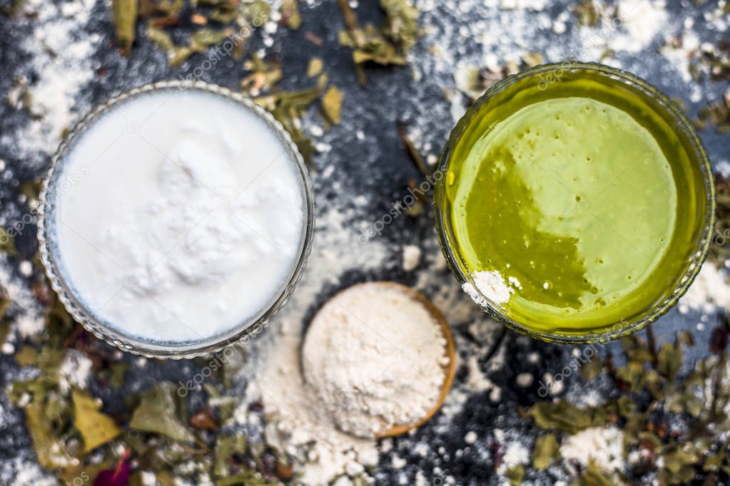 bowls with gram flour and neem paste with curd to preparation indian lilac face mask for acne and scars consisting on black wooden surface 