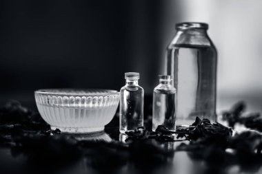 kasede ham bal ve ahşap yüzeyde gül yaprakları ile şişelerde çay ağacı ve hindistan cevizi yağları ile hint  