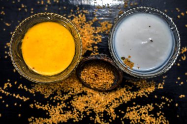 yoğurt ve çiğ yulaf ile ahşap yüzey üzerinde iyi karışık ham zerdeçal ile kase, yulaf için malzemeler yüz maskesi