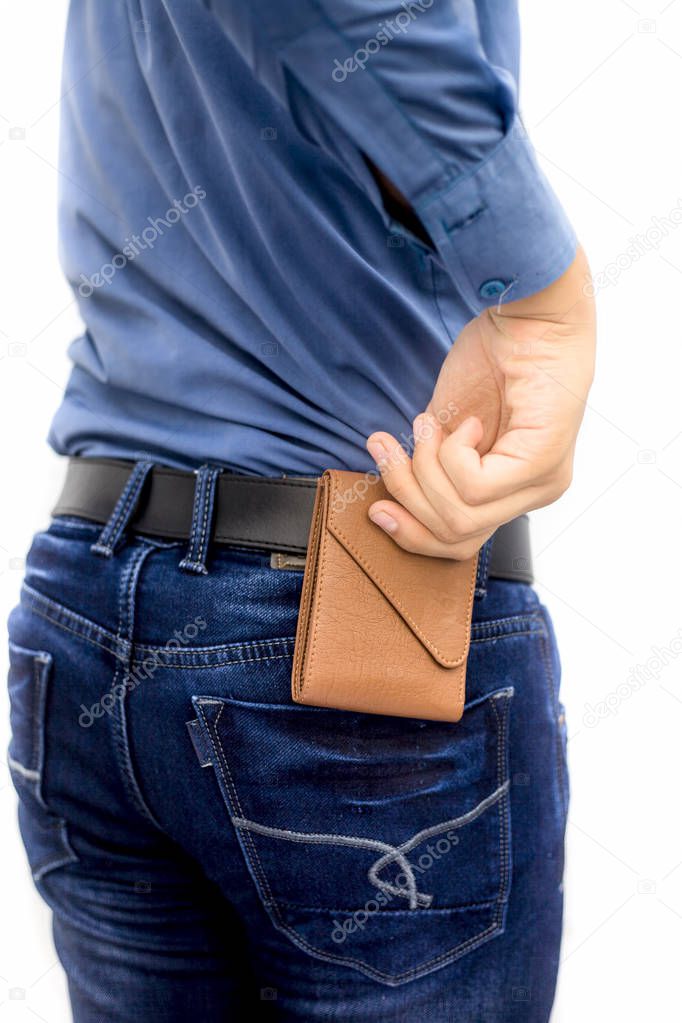 cropped shot of man putting wallet in jeans pocket
