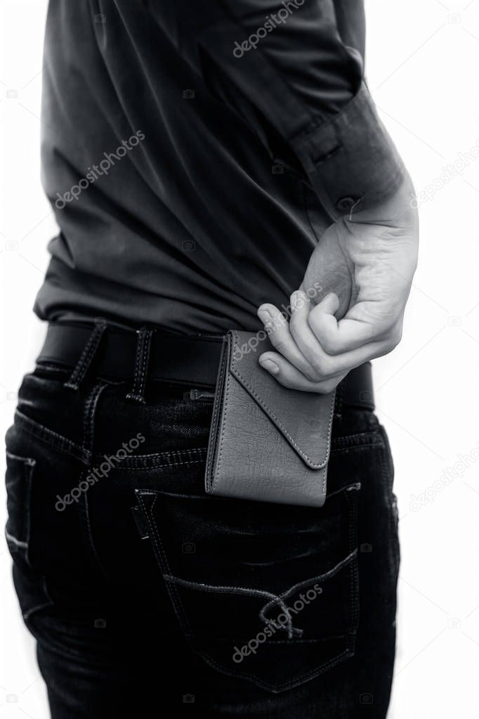 cropped shot of man putting wallet in jeans pocket