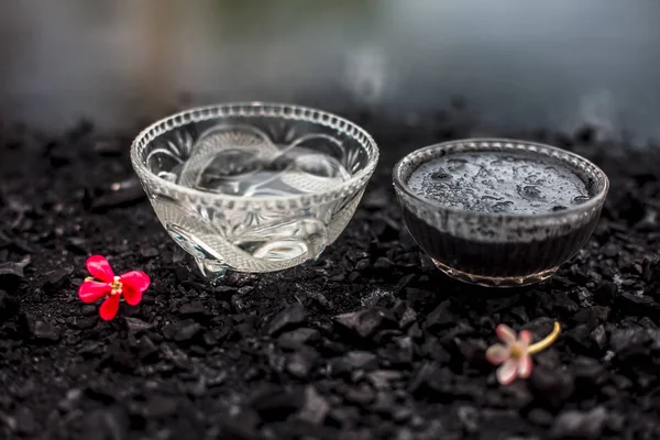 bowl with mask of activated charcoal with baking soda to detoxify strands and scalp, restore shine, repair damaged and split ends, and promote healthy