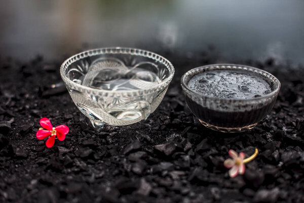 bowl with mask of activated charcoal with baking soda to detoxify strands and scalp, restore shine, repair damaged and split ends, and promote healthy