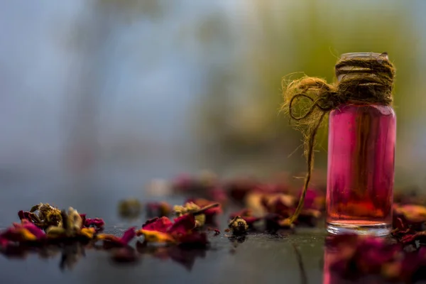 Ubtan/face mask/face pack of Multani mitti or fuller\'s earth on wooden surface in a glass bowl consisting of Multani mitti and rose water for the remedy or treatment of oily skin.On wooden surface.;