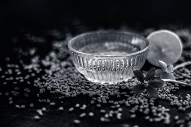 Limon suyu ile karıştırılmış çemen tohumu tozundan oluşan cam bir kapta ahşap yüzeyde kepek için ünlü doğal yöntem. Yüzeyinde mevcut çiğ limon ve çemen tohumu ile.