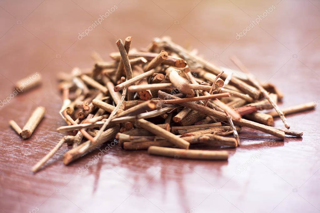 Bunch of Indian madderwort or madder root on the brown colored wooden surface also known as manjistha/manzistha/Rubia cordifolia/madder etc. with various health benefits derived from ancient Ayurveda.