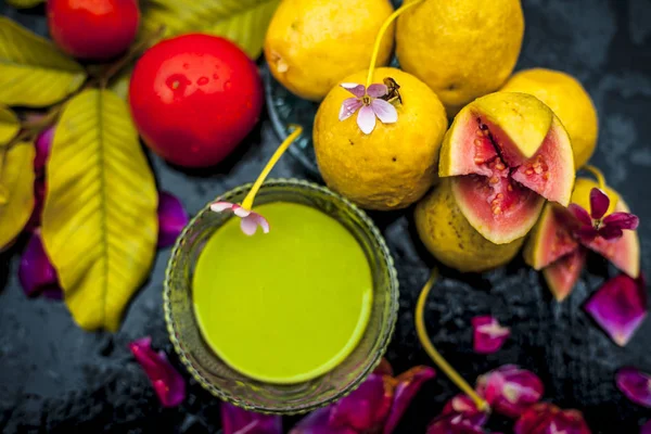 Best cheap face mask for tanned skin on wooden surface un a glass bowl consisting of guava leaves paste well mixed with some tomato pulp. Shot with entire ingredients with fantastic colors.