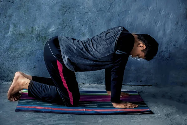 man doing yoga on floor mat