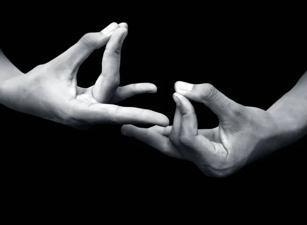 two male hands on black background