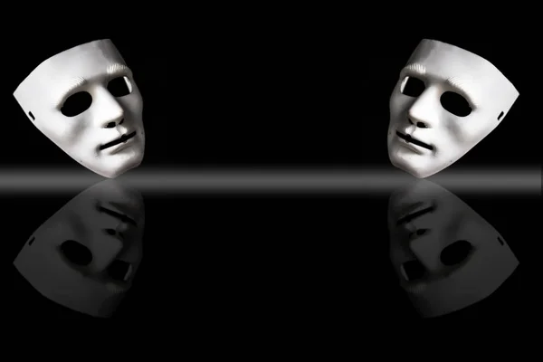 White-colored plastic face masks on black background