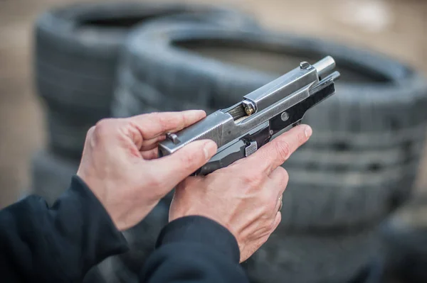 Close-up detail view of pistol, handgun, gun malfunctions. Clearance safety drills
