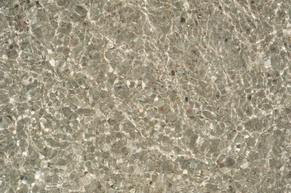 Homok, víz alatti textúra a háttér. Kristálytiszta víz — Stock Fotó