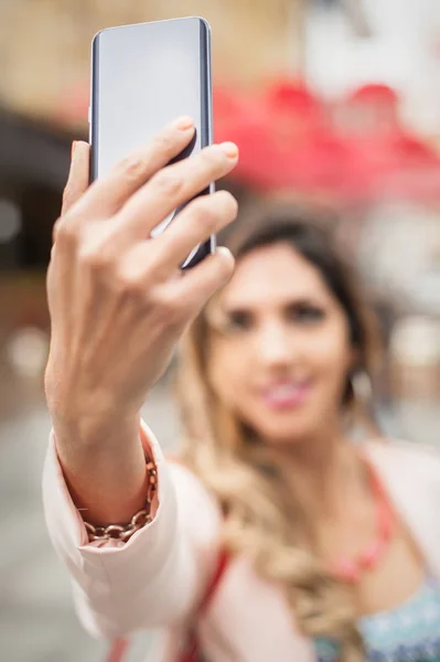 Lächelnde junge Frau macht Selfies mit Smartphone auf Stadtpfad — Stockfoto