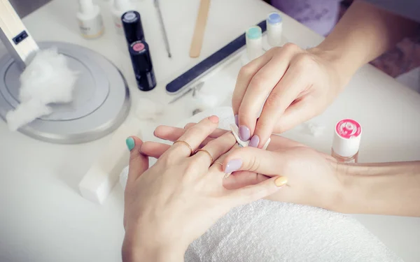 Finger nail treatment, grinding and polishing in beauty salon