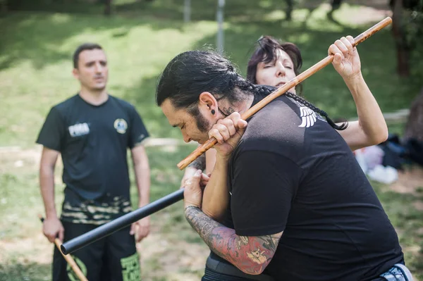 Large group of students practice filipino eskrima arnis stick