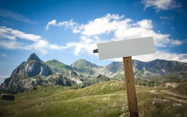 Blank white road sign board on the mountain. Adventure outdoor