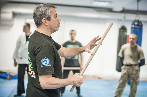 Large group of students practice filipino eskrima arnis stick