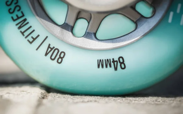 Close up of inline roller skates with blue wheels. Extreme sport. Concept about sport and leisure. Sport lifestyle. Fun time activity