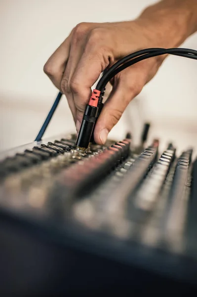 Behind the scene. Sound technician electric engineer adjusting sound elements backstage. Control audio panel. Audio mixing console