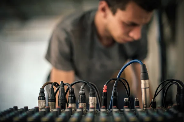 Behind the scene. Sound technician electric engineer adjusting sound elements backstage. Control audio panel. Audio mixing console