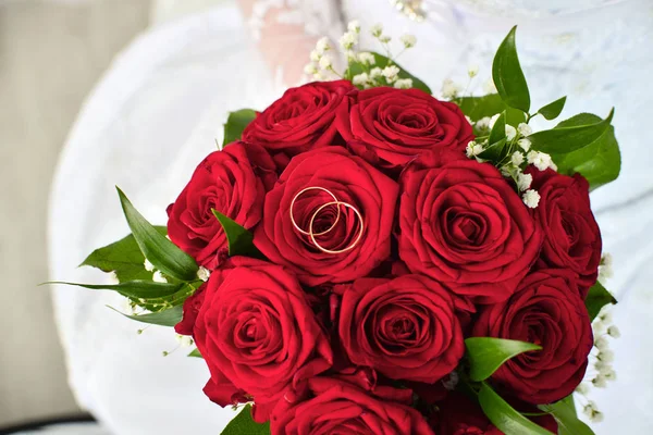 Wedding rings on red roses, wedding bouquet