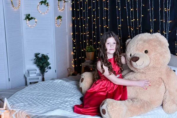 Beautiful girl with teddy bear  on bed  at home