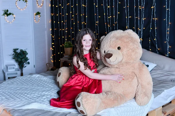 Beautiful girl with teddy bear  on bed  at home