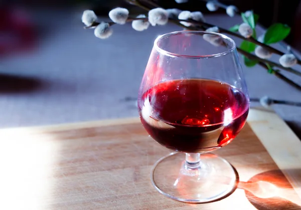 Romantický výhled se sklenkou vína a vrbové větve na dřevěné desce. — Stock fotografie