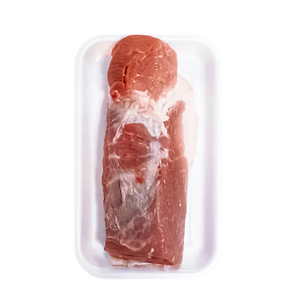 A piece of fresh meat on a pallet on a white isolated background — Stock Photo, Image
