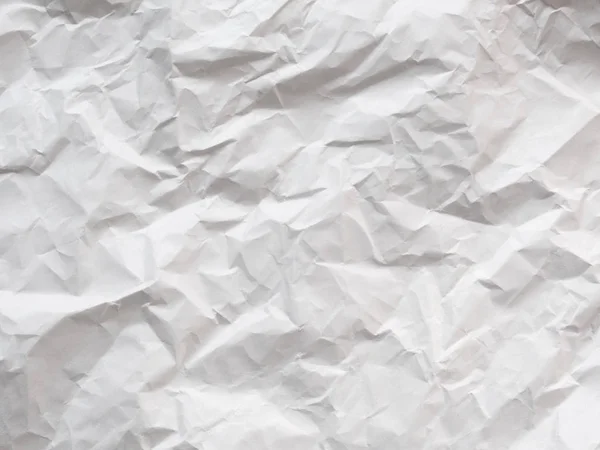 crumpled blank sheet of paper, light gray textured background