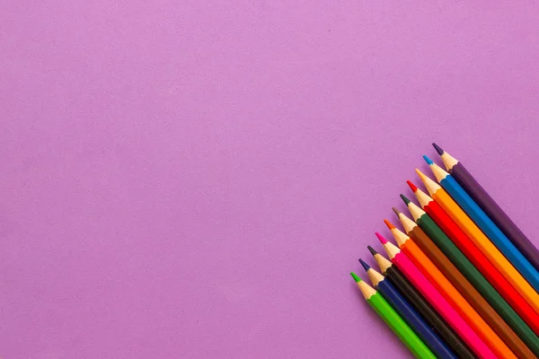 Collection of colored pencils on a purple background top view and copy space. Education, Back to school. Concept — Stock Photo, Image