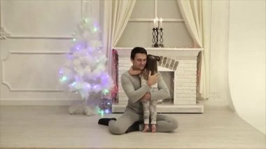 yoga poz şömine, yılbaşı ağacı, garland arka plan üzerinde katta oturan adam