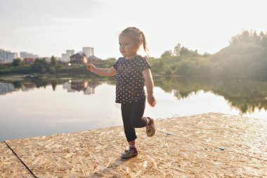 suya yakın iskelede oynayan kız