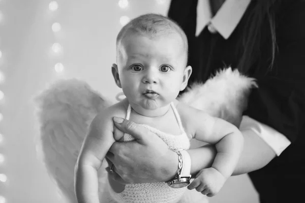 Boy with his mouth open is lying on a white background with wings behind his back. Angel Cupid looks up — Stock Photo, Image