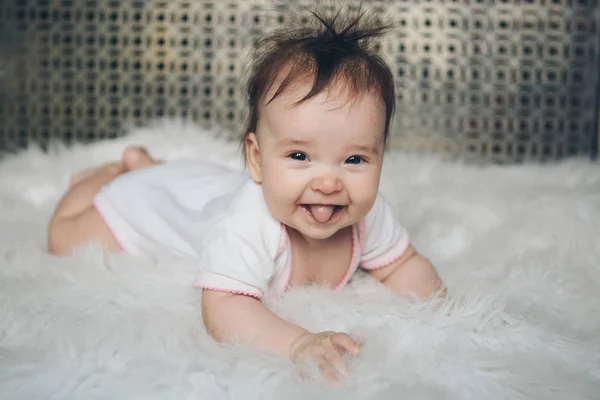 Retrato de um bebê recém-nascido com a língua saliente — Fotografia de Stock